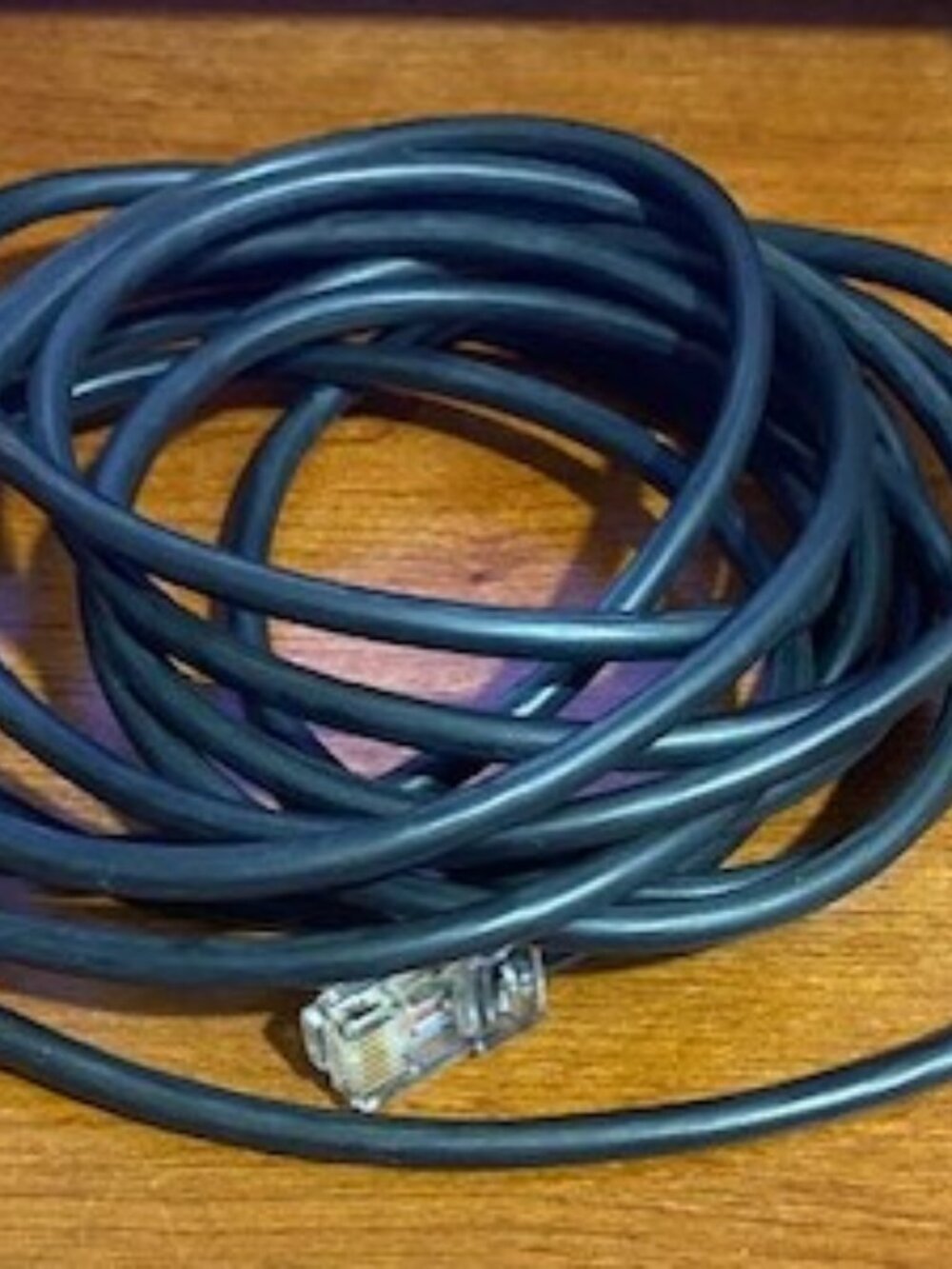 Black Ethernet cable, used for networking or connecting devices